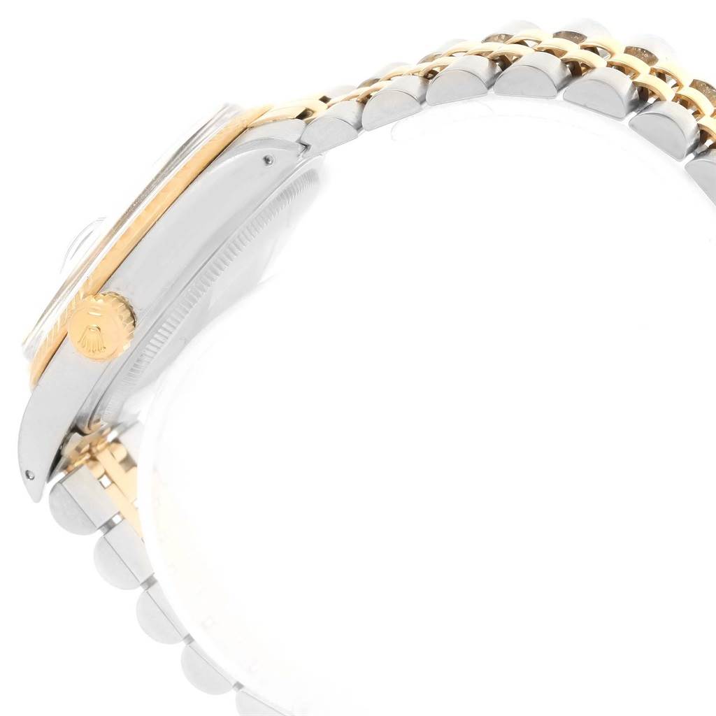 The image shows a side view of the Rolex Vintage Collection 16013 Men's Stainless Steel White Dial 16013 Men's Stainless Steel White Dial watch featuring its crown, bezel, and two-tone bracelet.