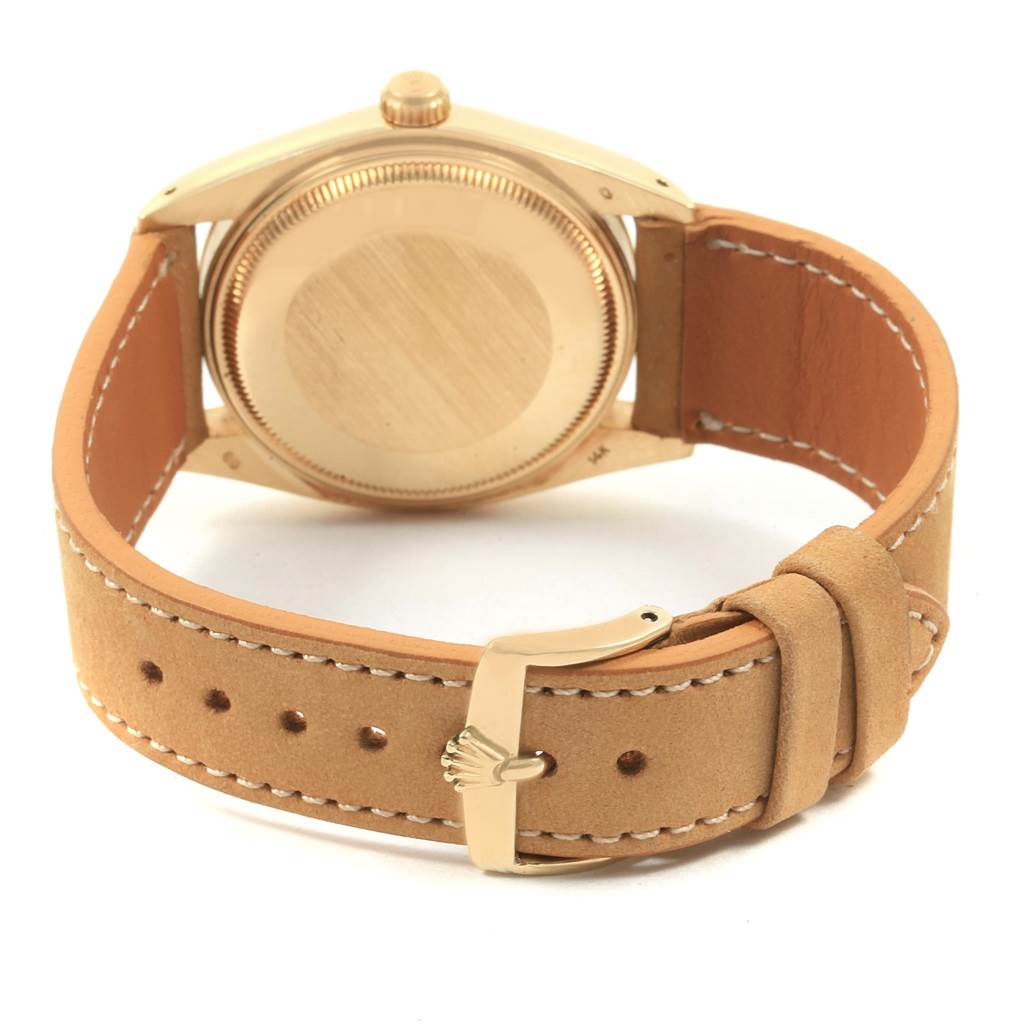 The image shows the back casing and leather strap of a Rolex Vintage Collection 1501 Men's Yellow Gold Champagne Dial 1501 Men's Yellow Gold Champagne Dial watch.