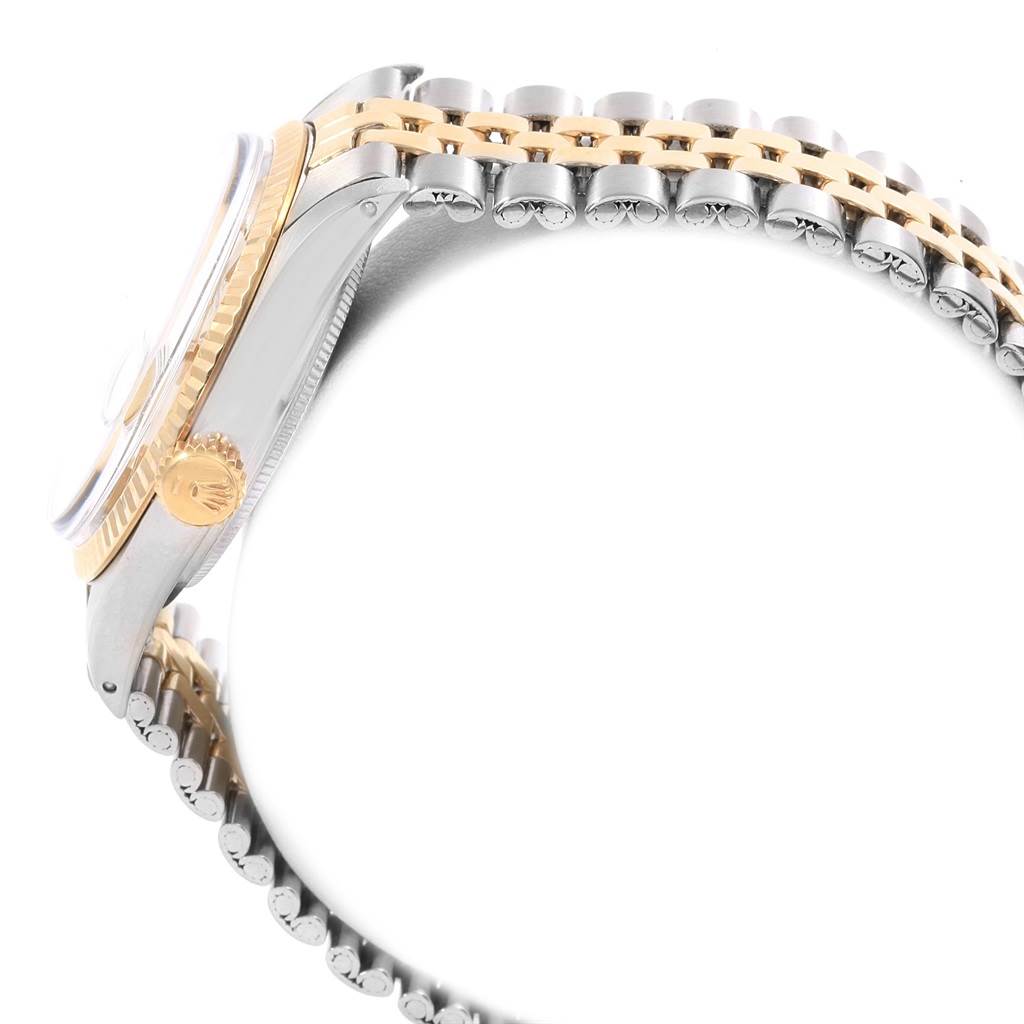 The image shows a side view of a Rolex Vintage Collection 1601 Men's Steel and Gold (two tone) Silver Dial 1601 Men's Steel and Gold (two tone) Silver Dial watch, focusing on its gold fluted bezel and two-tone bracelet.