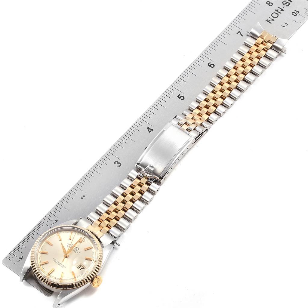 The image shows a Rolex Vintage Collection 1601 Men's Steel and Gold (two tone) Silver Dial 1601 Men's Steel and Gold (two tone) Silver Dial watch laid flat next to a ruler for scale.