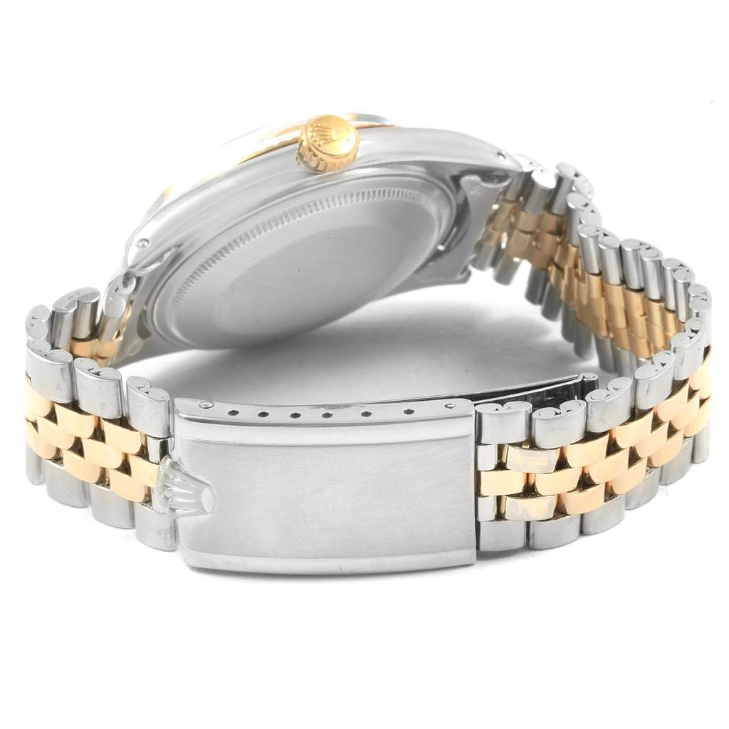 This image shows the back case, crown, and two-tone bracelet of a Rolex Vintage Collection 1601 Men's Steel and Gold (two tone) Silver Dial 1601 Men's Steel and Gold (two tone) Silver Dial watch.