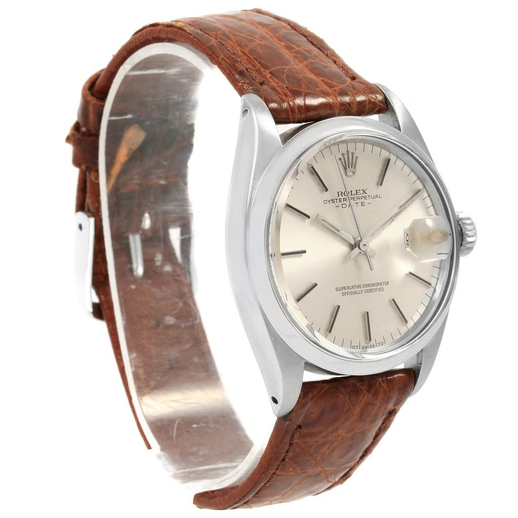 The image shows a side angle of a Vintage Collection Rolex watch featuring a silver dial, date display, and brown leather strap.