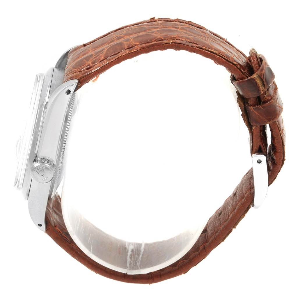 This image shows a side profile of a Rolex Vintage Collection 1500 Men's Stainless Steel Silver Dial 1500 Men's Stainless Steel Silver Dial watch, highlighting its leather band and case.