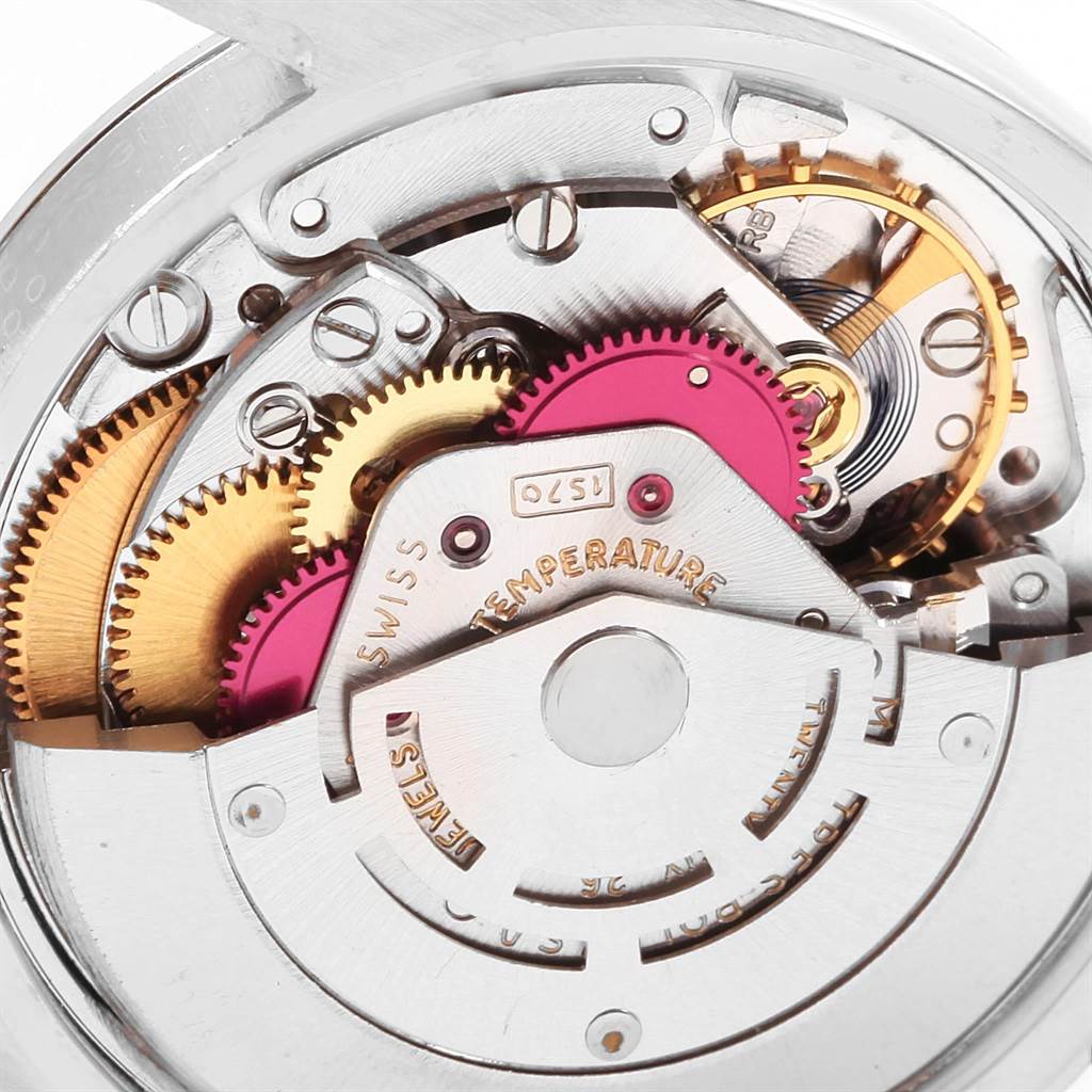 This close-up image of the Rolex Vintage Collection 1500 Men's Stainless Steel Silver Dial 1500 Men's Stainless Steel Silver Dial watch showcases its intricate internal mechanical parts and gears.