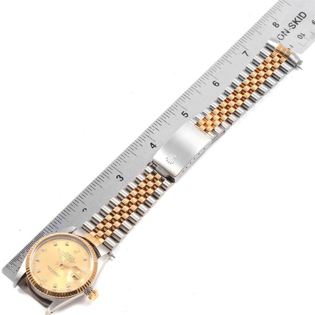 The image shows a Rolex Vintage Collection 16013 Men's Stainless Steel Champagne Dial 16013 Men's Stainless Steel Champagne Dial watch laid flat with its band extended next to a ruler for size reference.