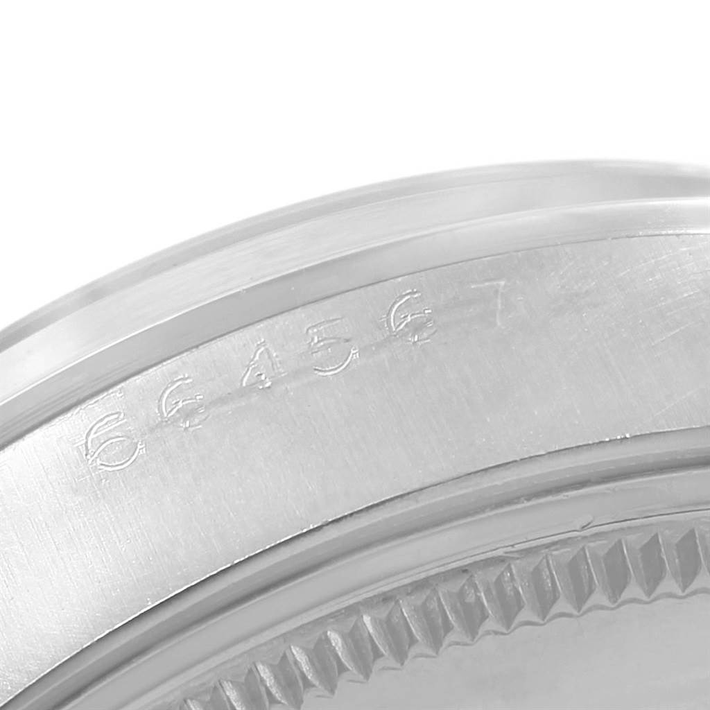 This close-up image shows the serial number engraving on the bezel edge of a Rolex Vintage Collection 1002 Men's Stainless Steel Silver Dial 1002 Men's Stainless Steel Silver Dial model.