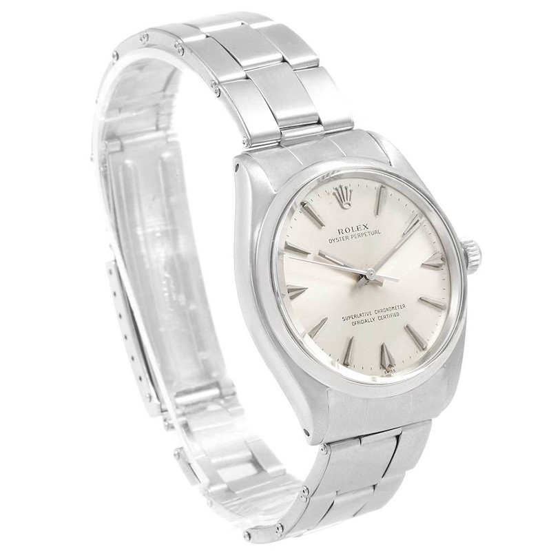 The Rolex Vintage Collection watch is shown at a three-quarter angle, highlighting its face, bezel, and bracelet.