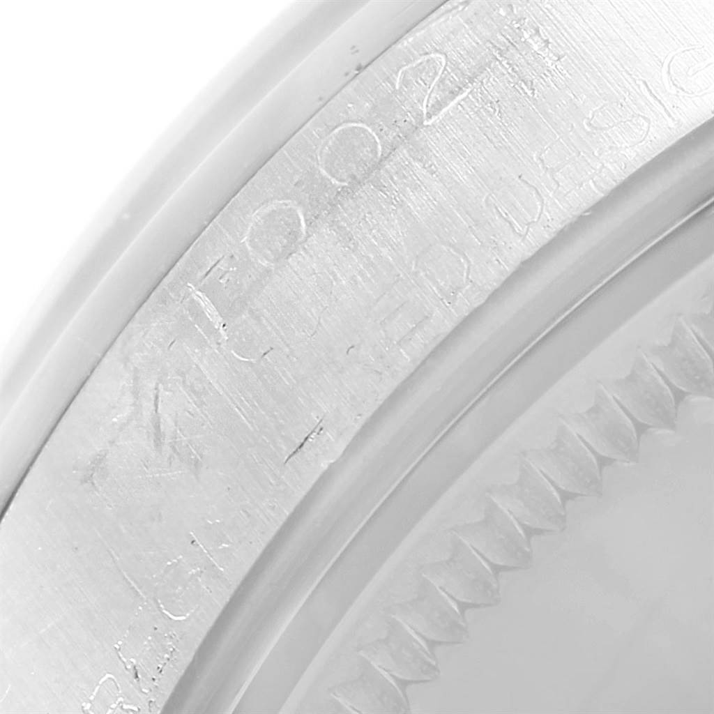This close-up image shows the engraved bezel and edge of the case back of a Vintage Collection model by Rolex.