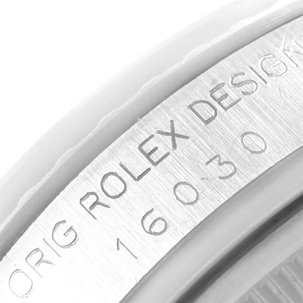 This image shows a close-up of the inner case back with the inscription "Rolex Design" and the model number of a Rolex Vintage Collection 16030 Men's Stainless Steel Silver Dial 16030 Men's Stainless Steel Silver Dial watch.