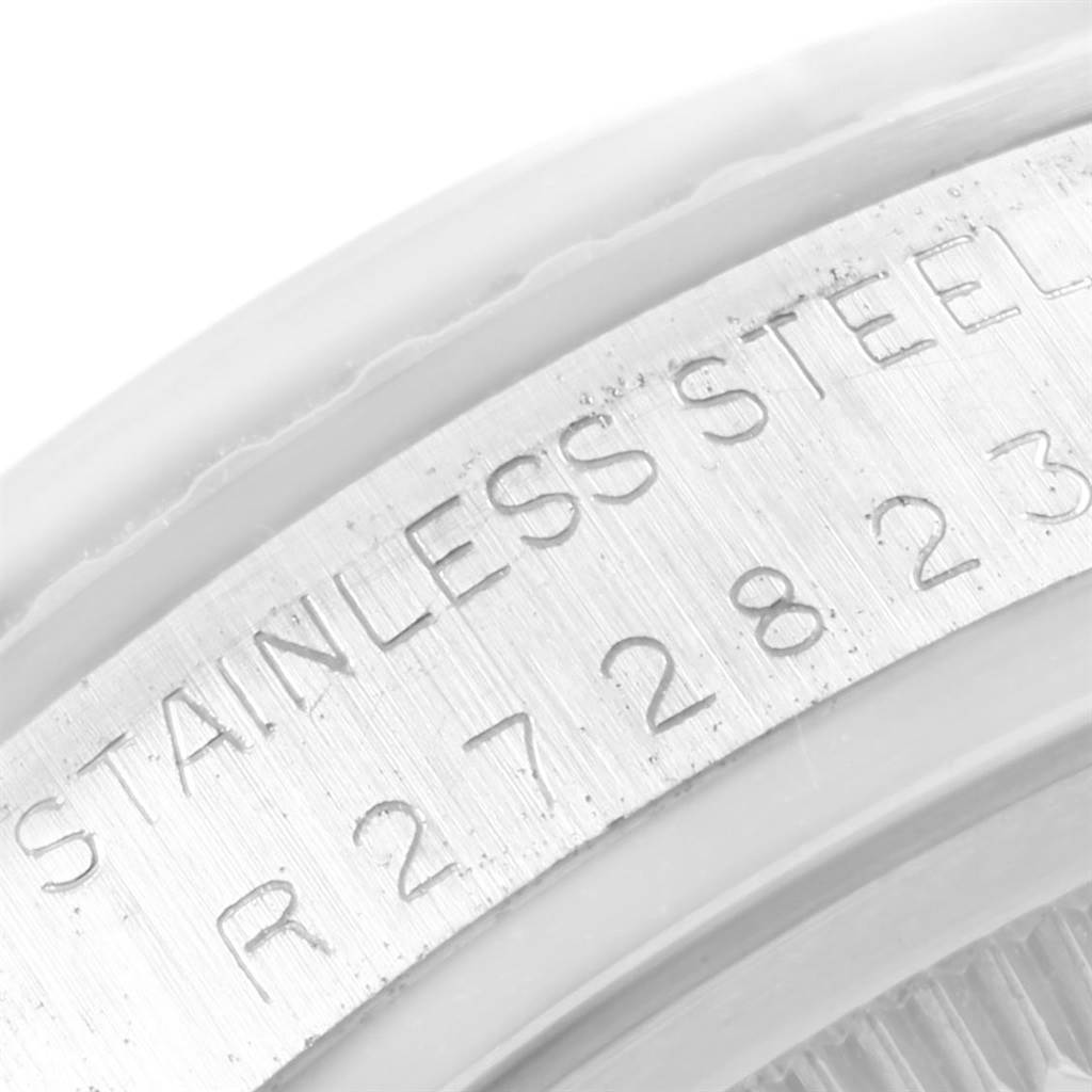 The image shows a close-up of a stainless steel part of a Vintage Collection watch by Rolex, specifically the engraved text area.