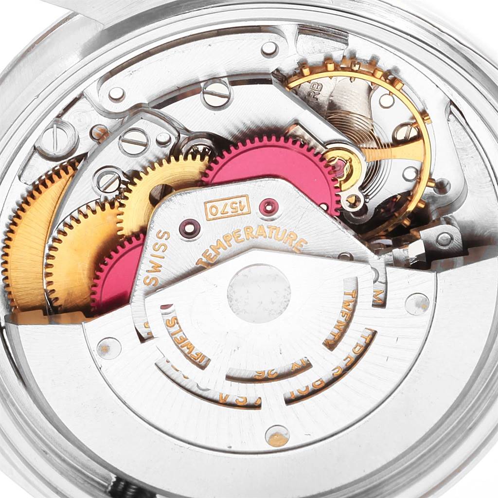 The image shows a close-up of the internal mechanical movement of a Vintage Collection Rolex watch.