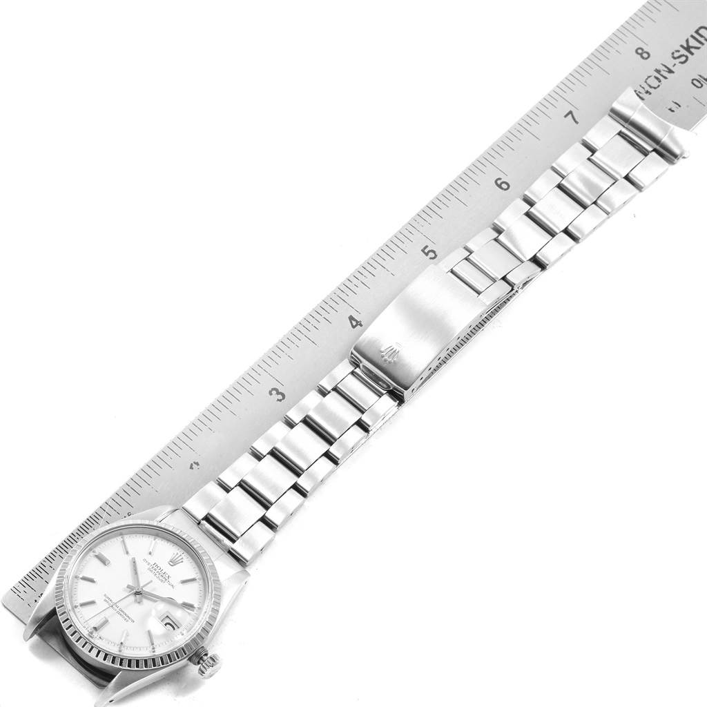 This image shows a Vintage Collection Rolex watch laid flat next to a ruler, highlighting its case, dial, and bracelet.