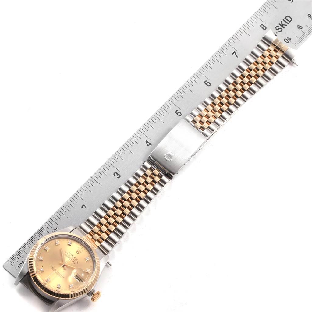 The Vintage Collection Rolex watch is shown from a top-down angle, displaying the bezel, face, crown, and bracelet alongside a ruler.