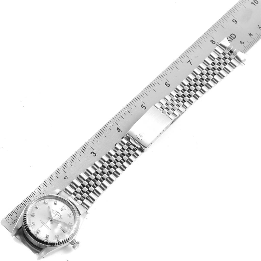 The image shows the Vintage Collection Rolex watch, displaying its face, crown, metal bracelet, and clasp, measured against a ruler.
