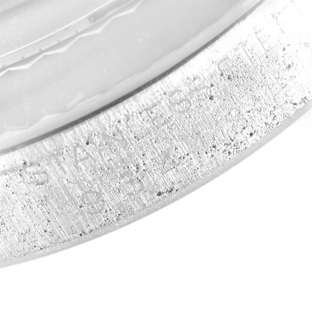 This image shows a close-up of the side edge of the Vintage Collection Rolex watch, focusing on the stainless steel texture and engravings.