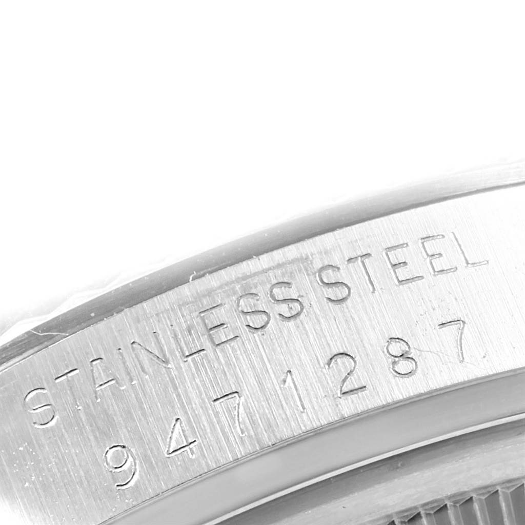 This image shows a close-up of the stainless steel back case edge of a Rolex Vintage Collection 16014 Men's Stainless Steel Silver Dial 16014 Men's Stainless Steel Silver Dial model with serial number engraving.
