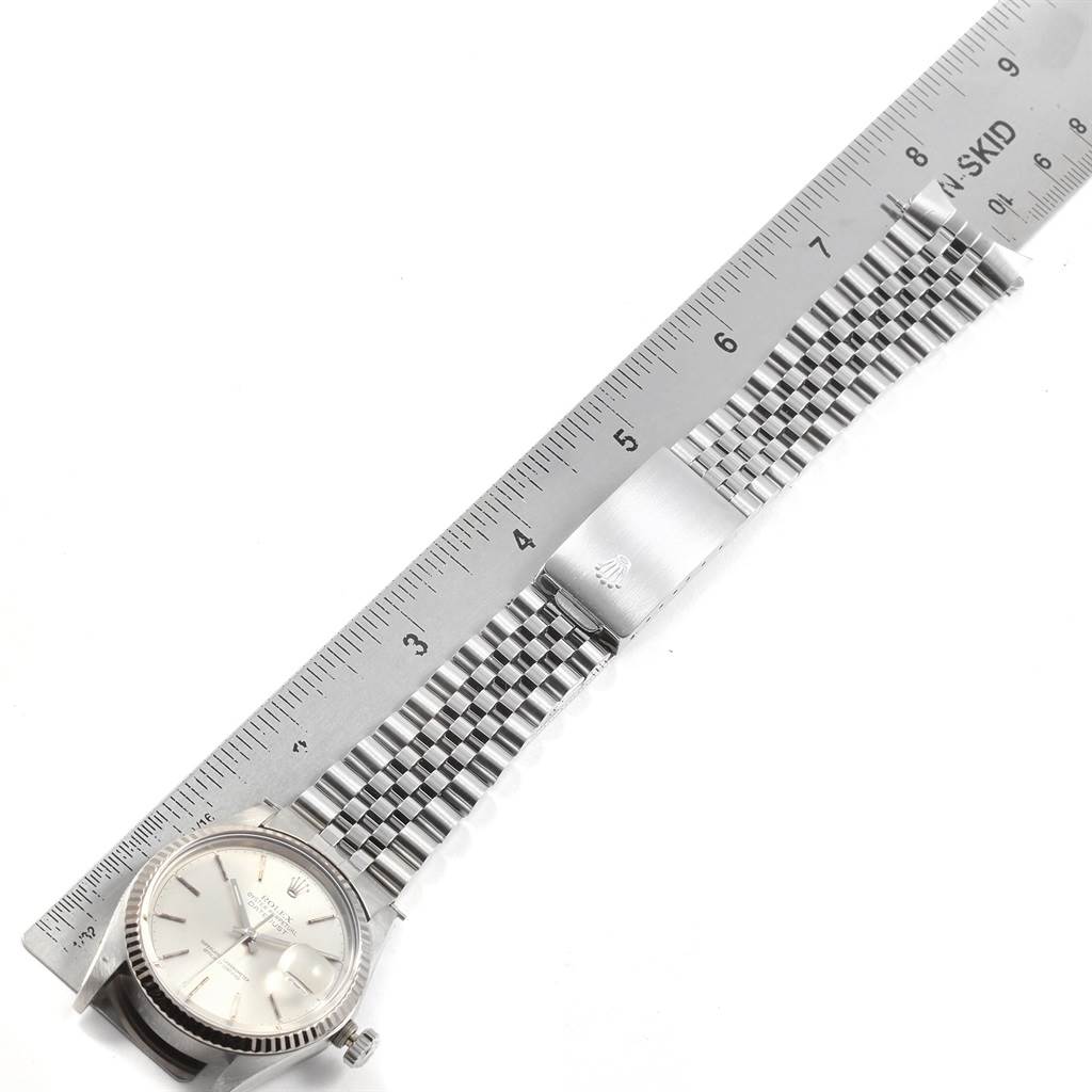 The image shows a Rolex Vintage Collection 16014 Men's Stainless Steel Silver Dial 16014 Men's Stainless Steel Silver Dial watch laid next to a ruler, displaying its face, bezel, and metal bracelet.