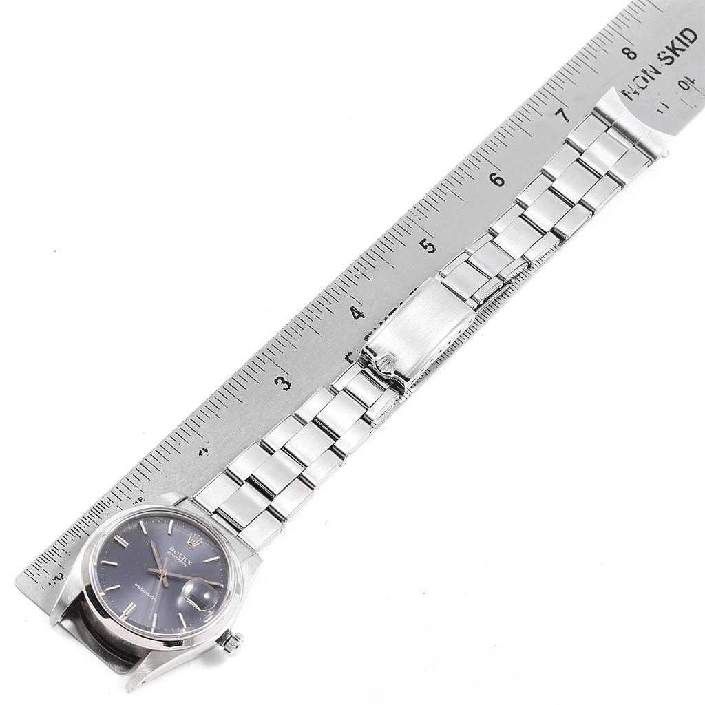 The image shows a Rolex Vintage Collection 6694 Men's Stainless Steel Grey Dial 6694 Men's Stainless Steel Grey Dial watch with a metal strap alongside a ruler for size reference, viewed from the top.
