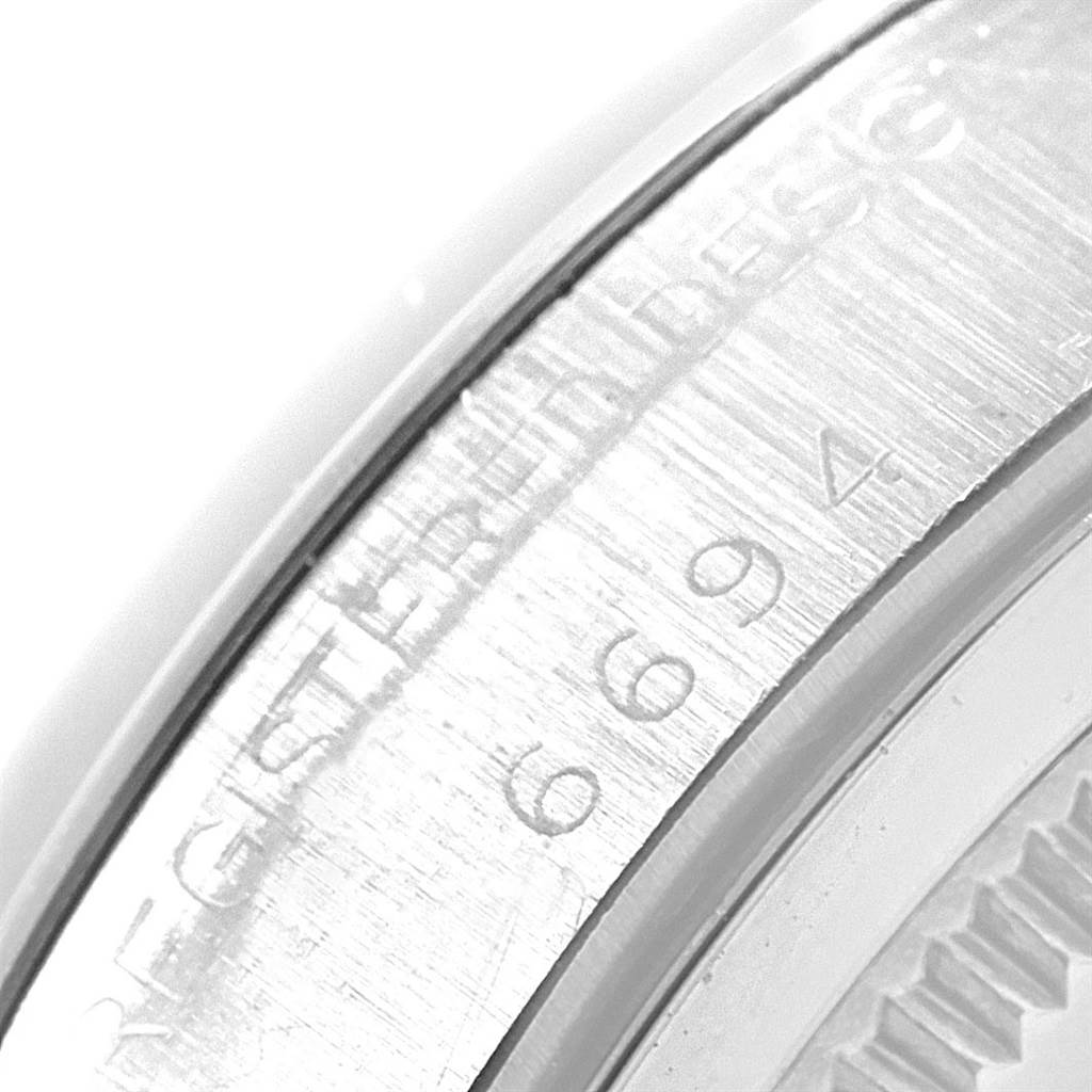 The image shows a close-up of the engraved serial number on the side of the case of a Rolex Vintage Collection 6694 Men's Stainless Steel Grey Dial 6694 Men's Stainless Steel Grey Dial watch.