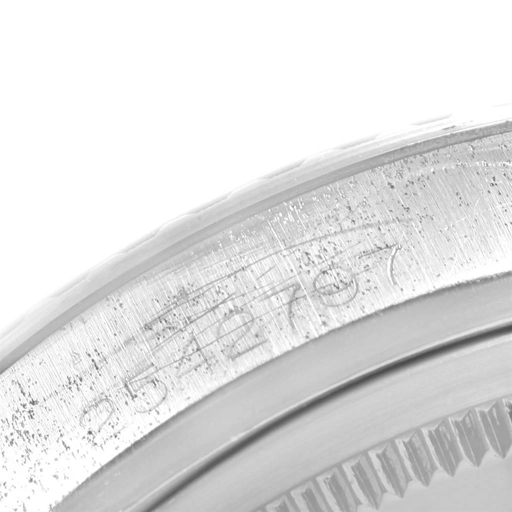 The image shows a close-up of the engraved serial number on the bezel of a Rolex Vintage Collection 1603 Men's Stainless Steel Silver Dial 1603 Men's Stainless Steel Silver Dial watch.