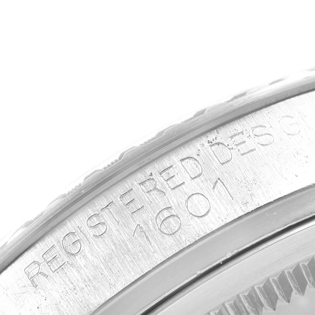 This image shows a close-up of the side edge of the Rolex Vintage Collection 1603 Men's Stainless Steel Silver Dial 1603 Men's Stainless Steel Silver Dial model 1601, highlighting the engraved serial number.