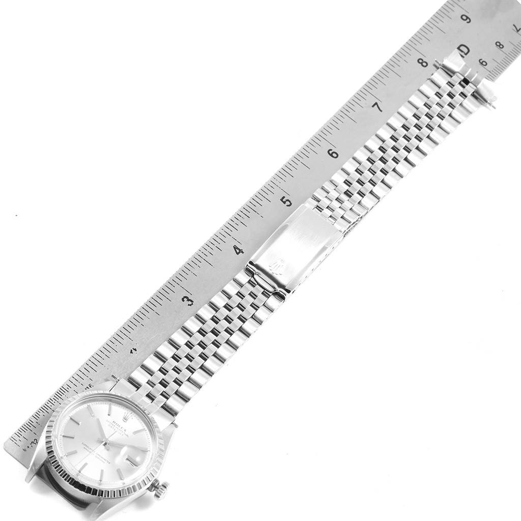 The Rolex Vintage Collection 1603 Men's Stainless Steel Silver Dial 1603 Men's Stainless Steel Silver Dial watch is shown from a top-down angle, with a ruler measuring its metal band length.