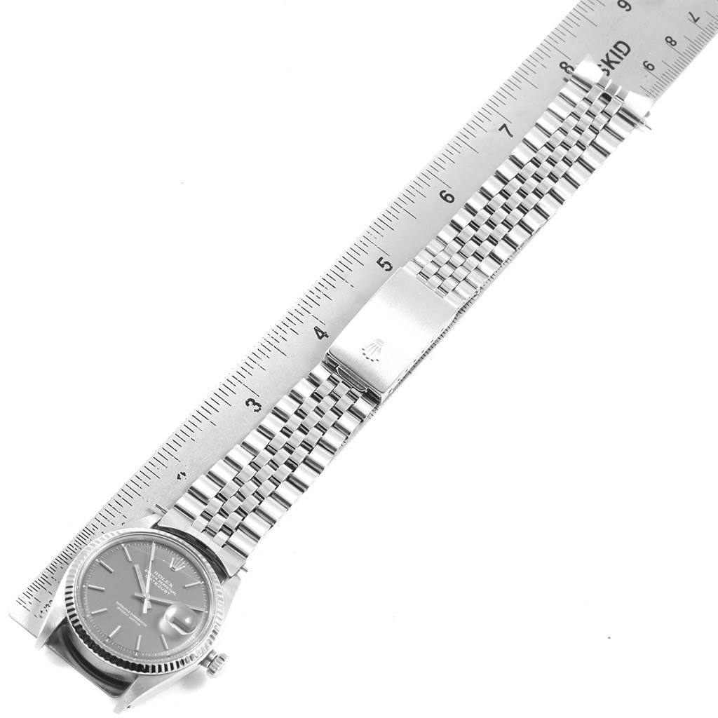 This image shows a Rolex Vintage Collection 1601 Men's Stainless Steel Grey Dial 1601 Men's Stainless Steel Grey Dial watch laid flat, displaying the face, band, and clasp with a ruler for size reference.