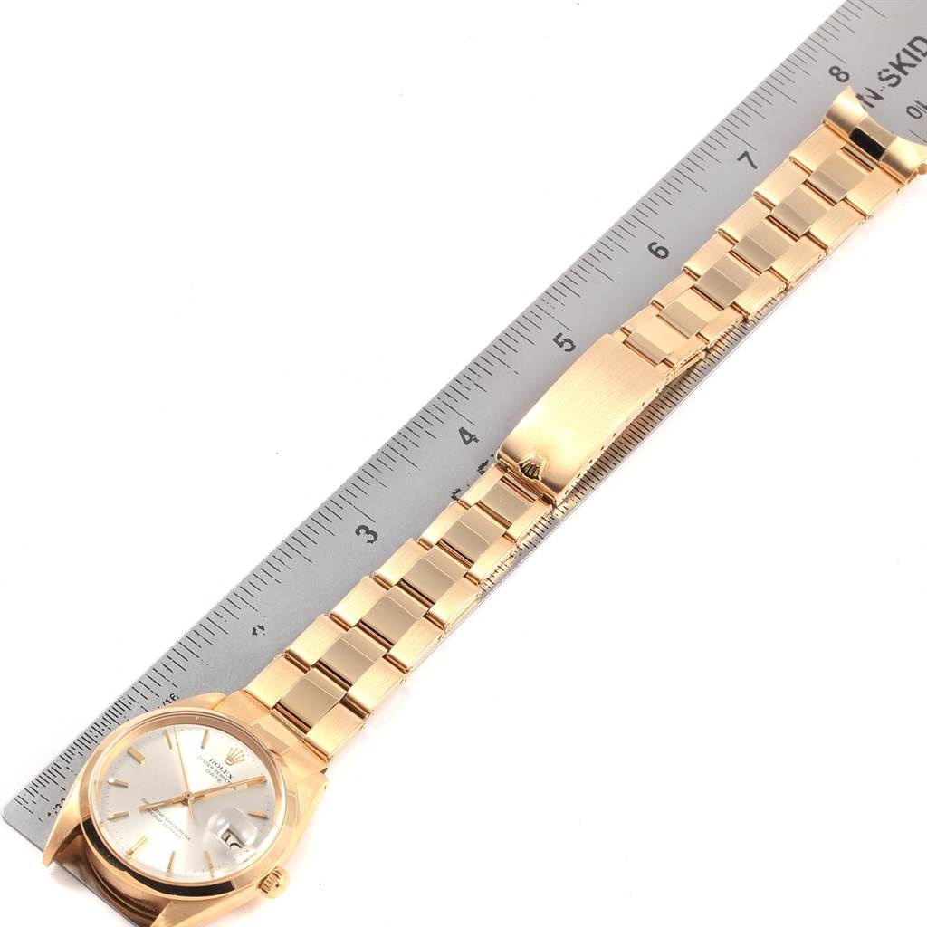 The watch, a Vintage Collection model by Rolex, is shown from a top-down angle next to a ruler, displaying its band and face.