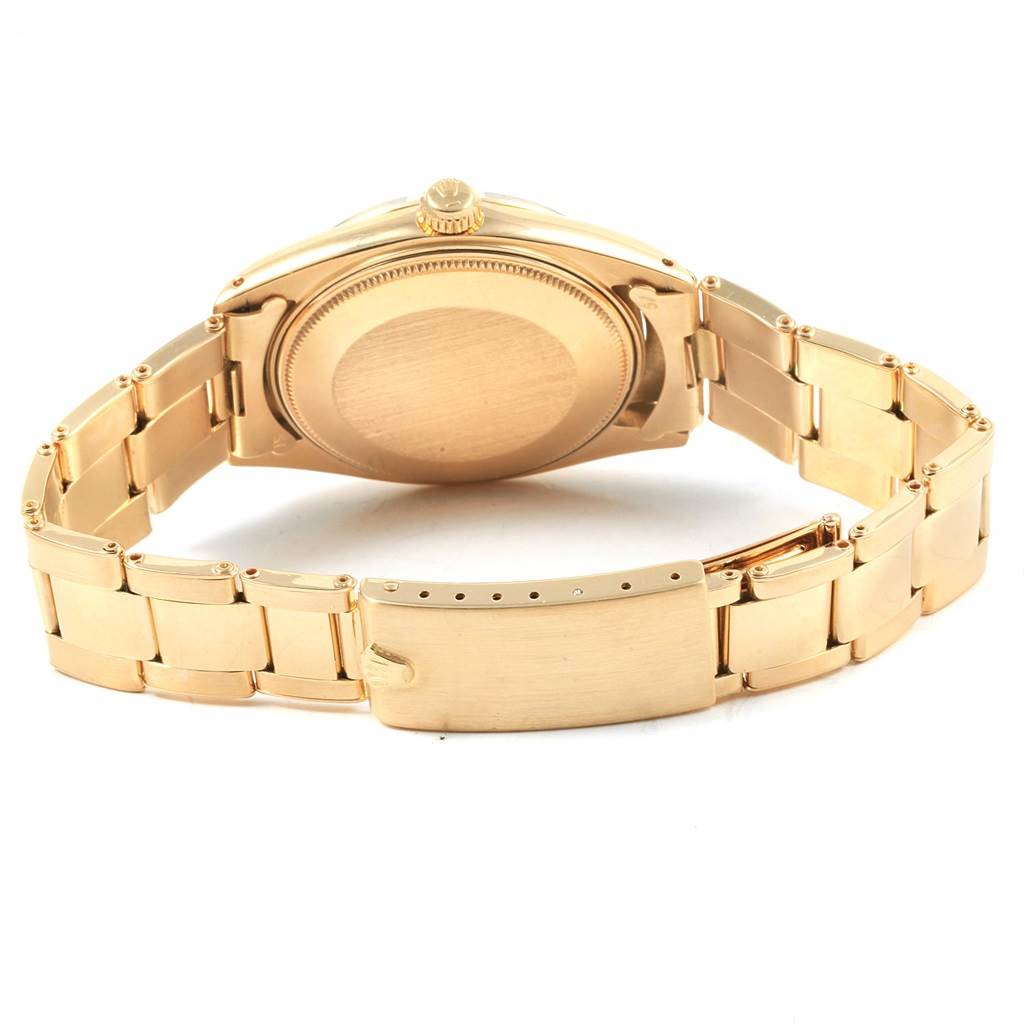 The image shows the back case and bracelet of the Rolex Vintage Collection 1500 Men's Yellow Gold Silver Dial 1500 Men's Yellow Gold Silver Dial watch at an angle.