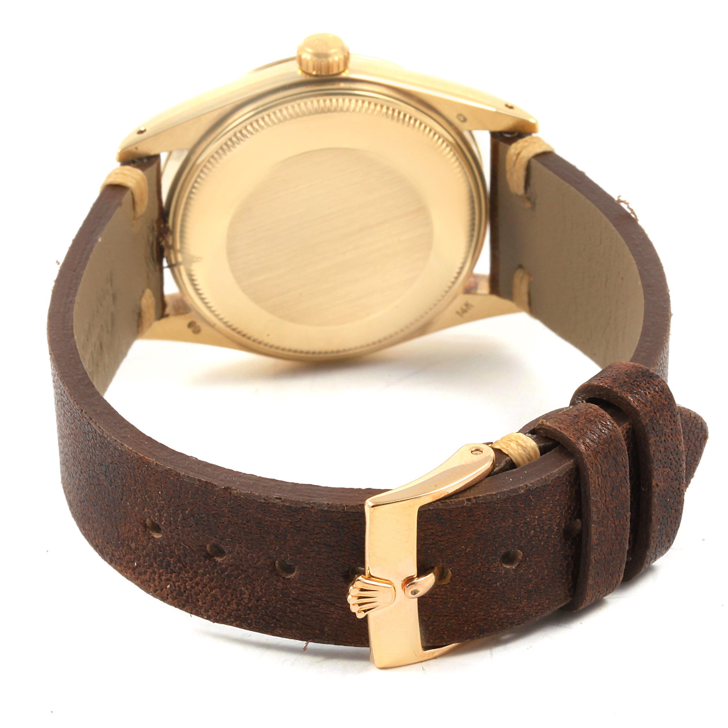 The image shows the back view of the Rolex Vintage Collection 15037 Men
s Yellow Gold Champagne Dial 15037 Men
s Yellow Gold Champagne Dial watch, highlighting the case back and brown leather strap with buckle.
