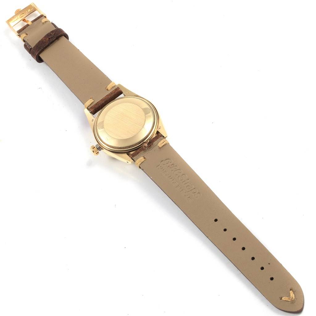 This image shows the back angle of the Rolex Vintage Collection 15037 Men
s Yellow Gold Champagne Dial 15037 Men
s Yellow Gold Champagne Dial watch, highlighting its leather strap and gold case back.