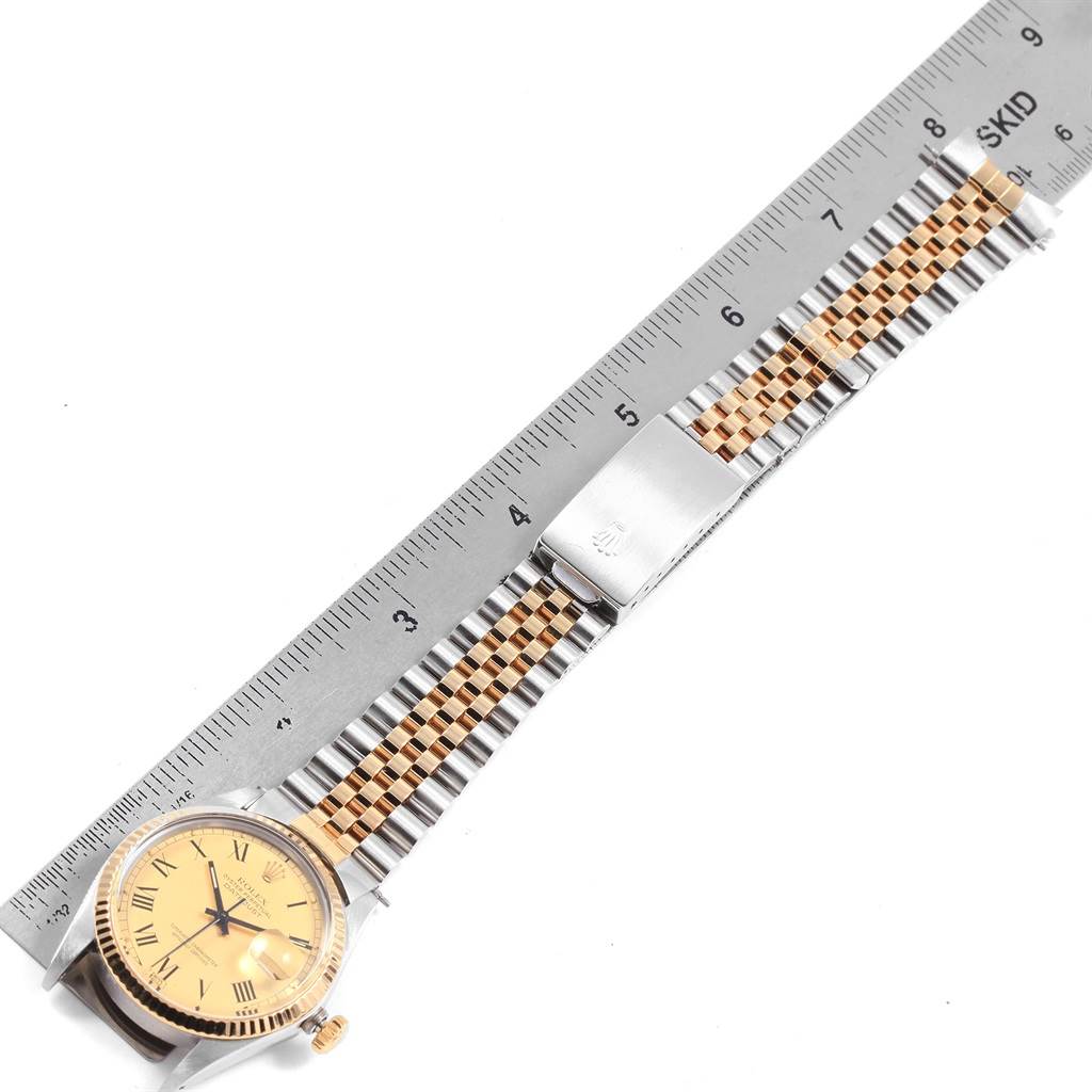 The image shows a Rolex Vintage Collection 16013 Men
s Stainless Steel Champagne Dial 16013 Men
s Stainless Steel Champagne Dial watch laid flat, displaying its face, bezel, crown, and bracelet with a ruler for scale.