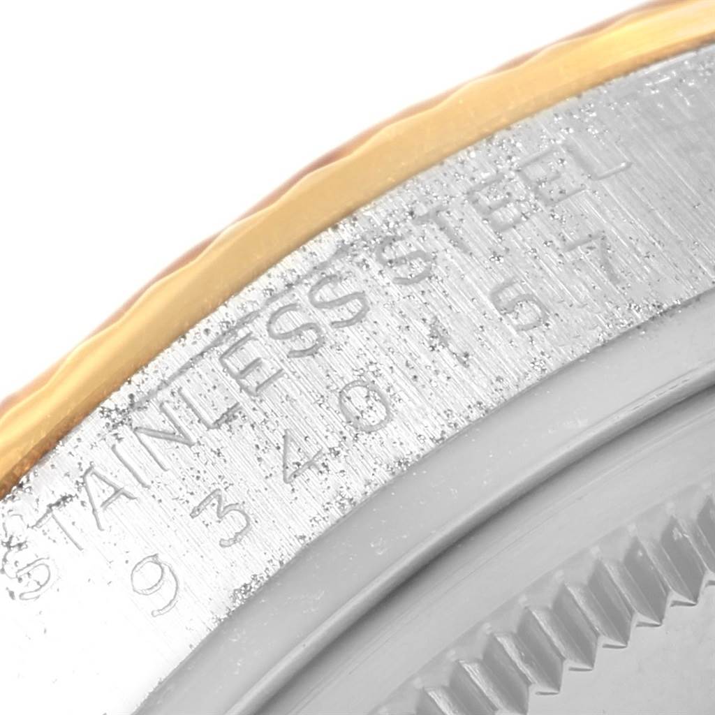 This close-up image shows the stainless steel and gold bezel of the Rolex Vintage Collection 16013 Men
s Stainless Steel Champagne Dial 16013 Men
s Stainless Steel Champagne Dial watch, featuring part of its inscription.