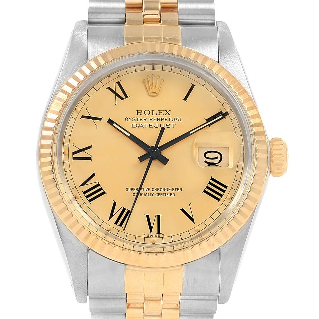 The image shows a front view of the Rolex Vintage Collection 16013 Men
s Stainless Steel Champagne Dial 16013 Men
s Stainless Steel Champagne Dial Oyster Perpetual Datejust watch with a gold and silver band and Roman numerals.