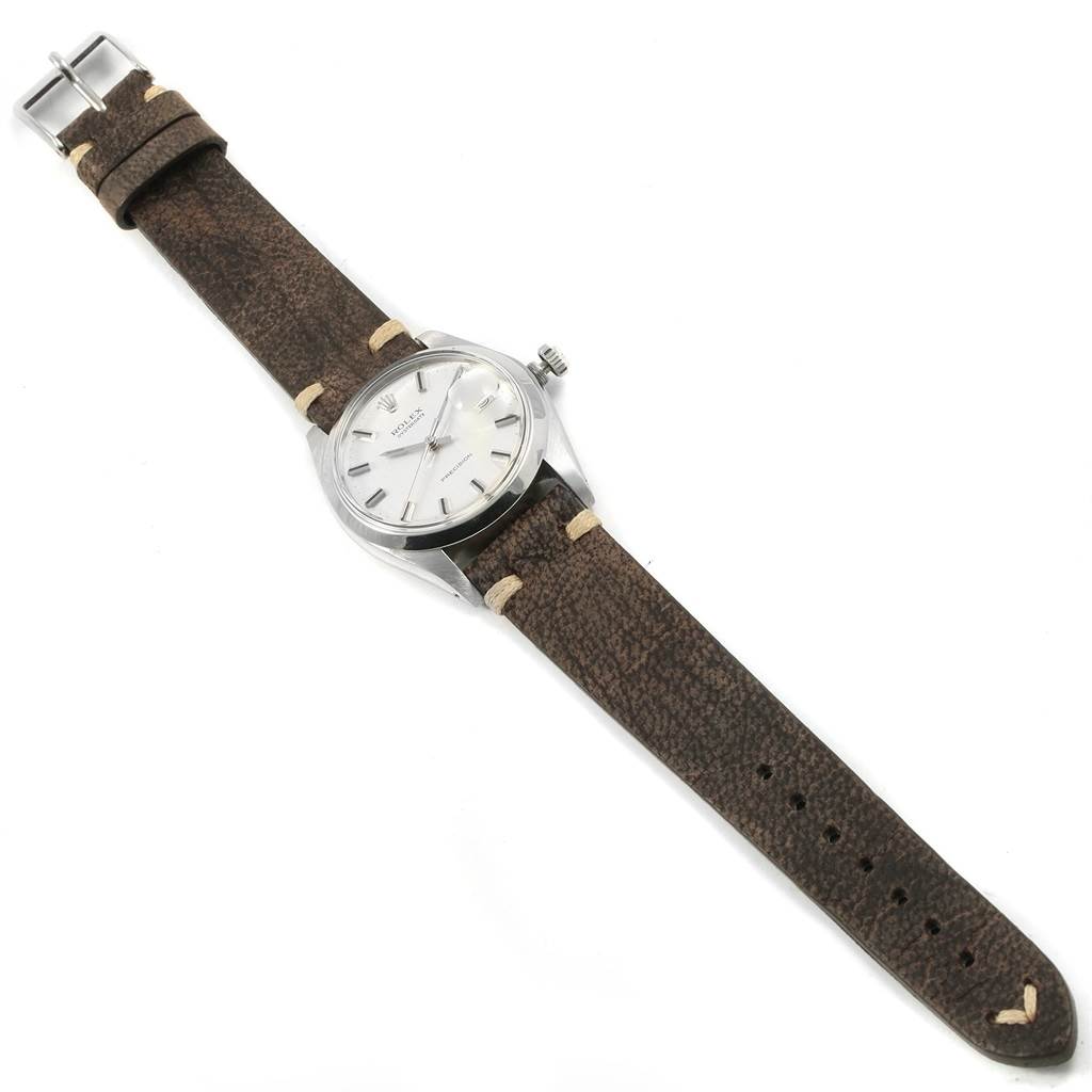 The image shows a Rolex Vintage Collection 6694 Men's Stainless Steel Silver Dial 6694 Men's Stainless Steel Silver Dial watch from a top-down angle, displaying the entire watch including the face, strap, and buckle.