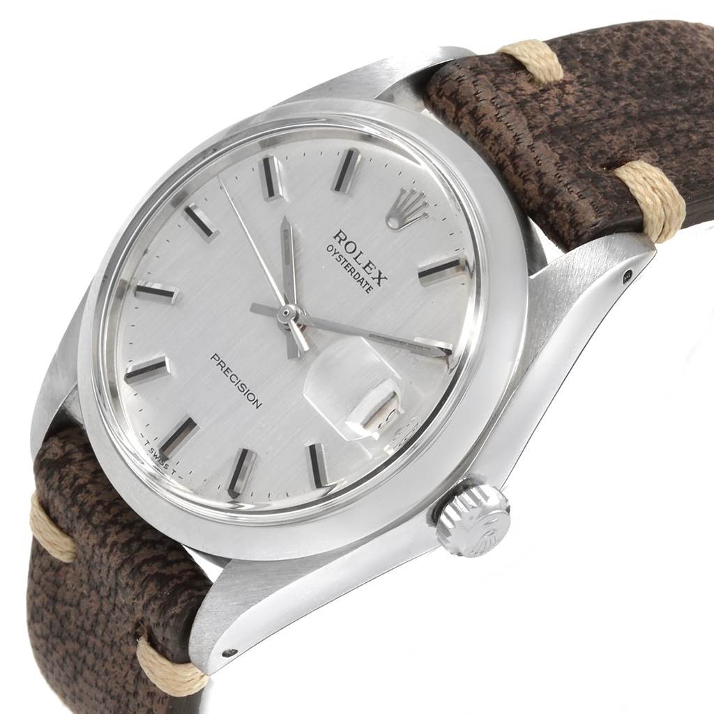 The vintage Rolex watch is shown at a slight angle, featuring the face, case, crown, and part of the brown leather strap.