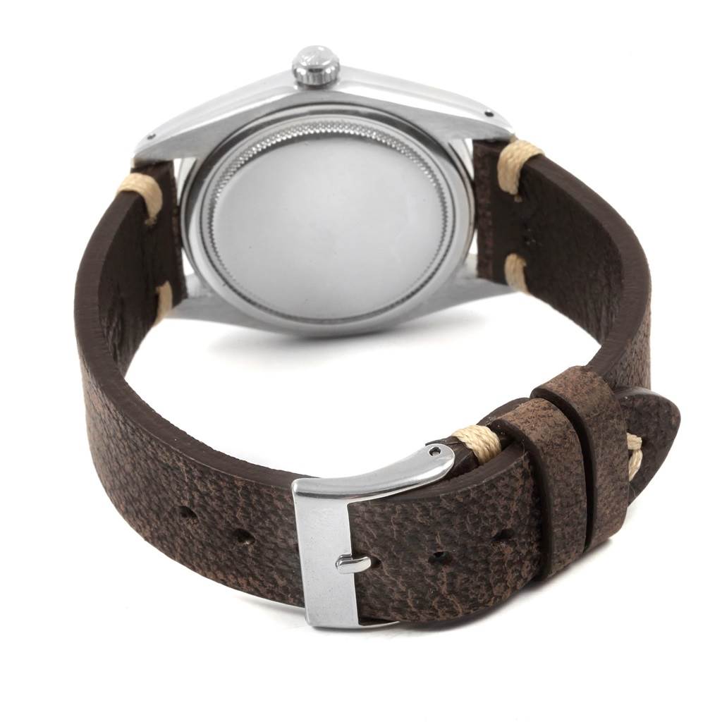 The image shows the back of a Rolex Vintage Collection 6694 Men's Stainless Steel Silver Dial 6694 Men's Stainless Steel Silver Dial watch with a leather strap and buckle.