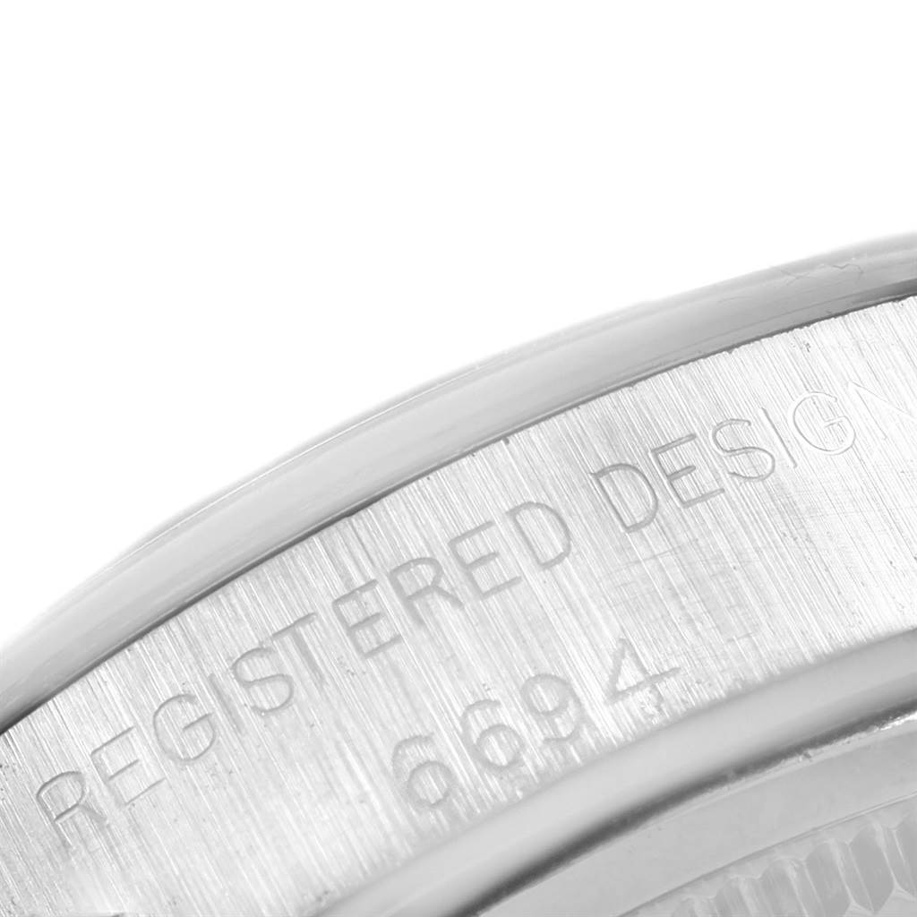 This image shows a close-up of the engraved edge on a Rolex Vintage Collection 6694 Men's Stainless Steel Silver Dial 6694 Men's Stainless Steel Silver Dial watch.