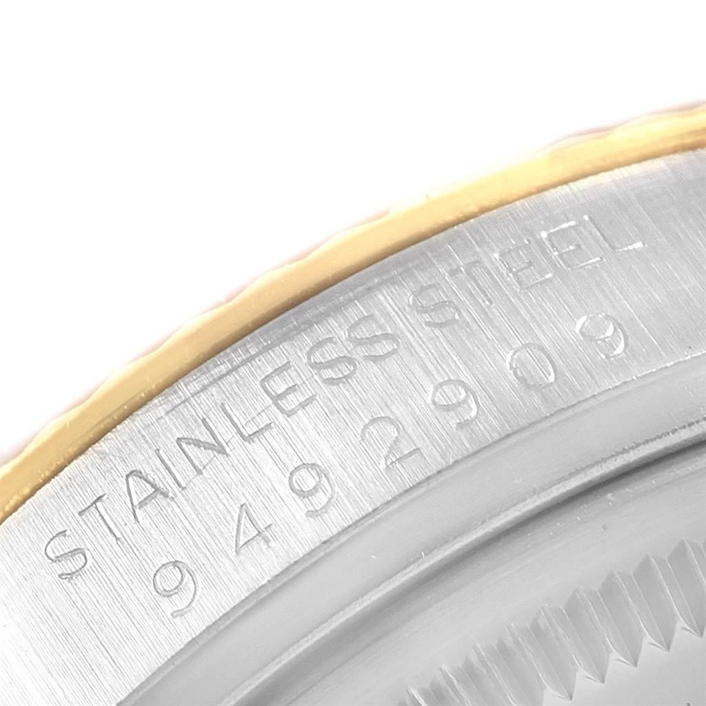 This image shows a close-up of the stainless steel casing and serial number on the bezel of a Vintage Collection Rolex watch.