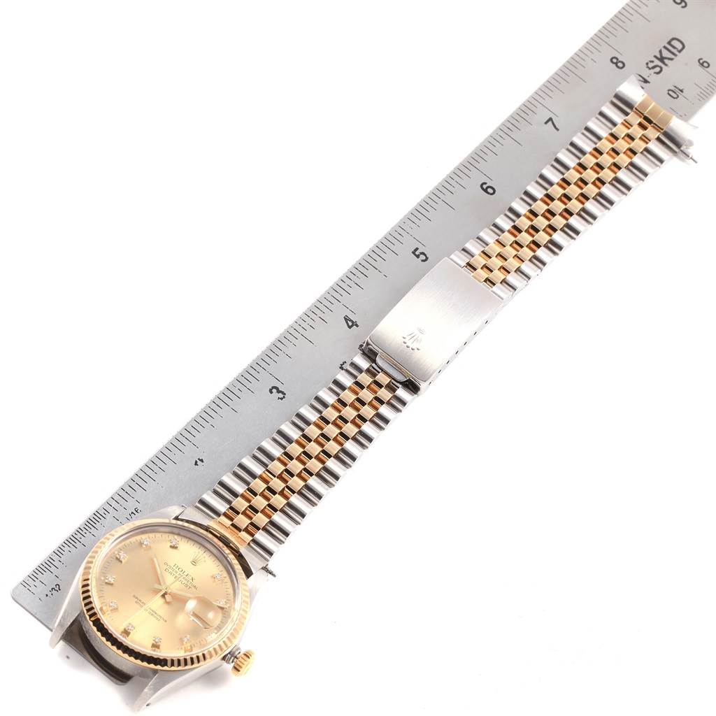 The image shows a Vintage Collection Rolex watch laid flat with a ruler for scale, highlighting its face, gold and steel bracelet, and clasp.