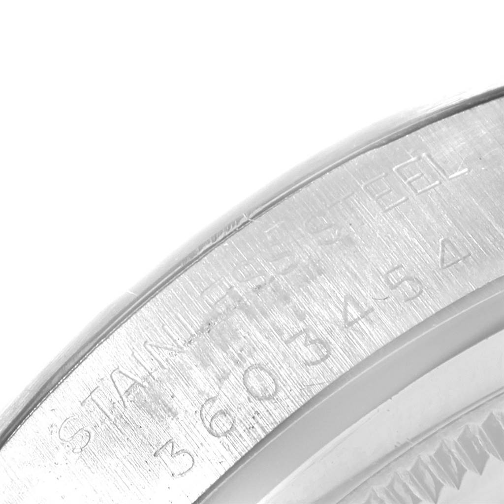 The image shows a close-up angle of the serial number and material engraving on the outer edge of a Rolex Vintage Collection 6694 Men
s Stainless Steel Silver Dial 6694 Men
s Stainless Steel Silver Dial watch case.