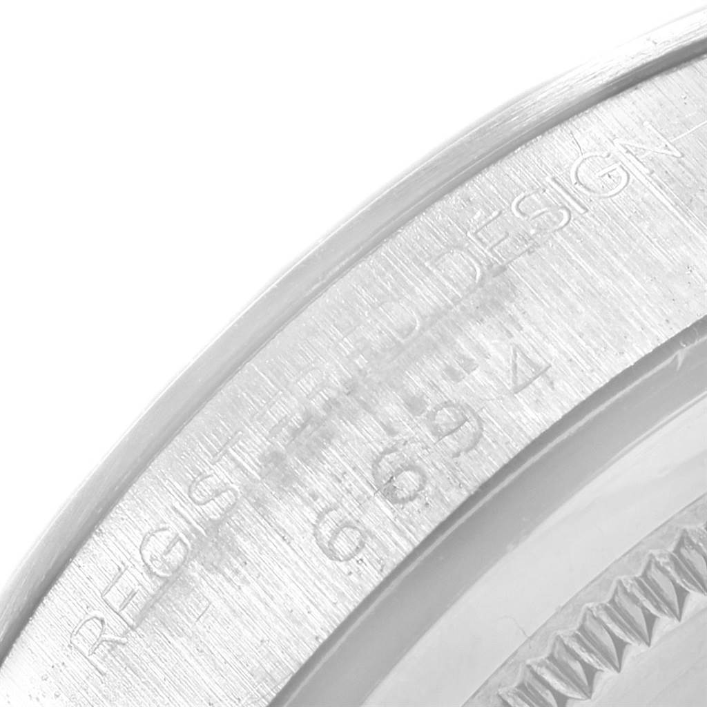 This close-up image shows the side of a Rolex Vintage Collection 6694 Men
s Stainless Steel Silver Dial 6694 Men
s Stainless Steel Silver Dial model with engraved text on the watch case.
