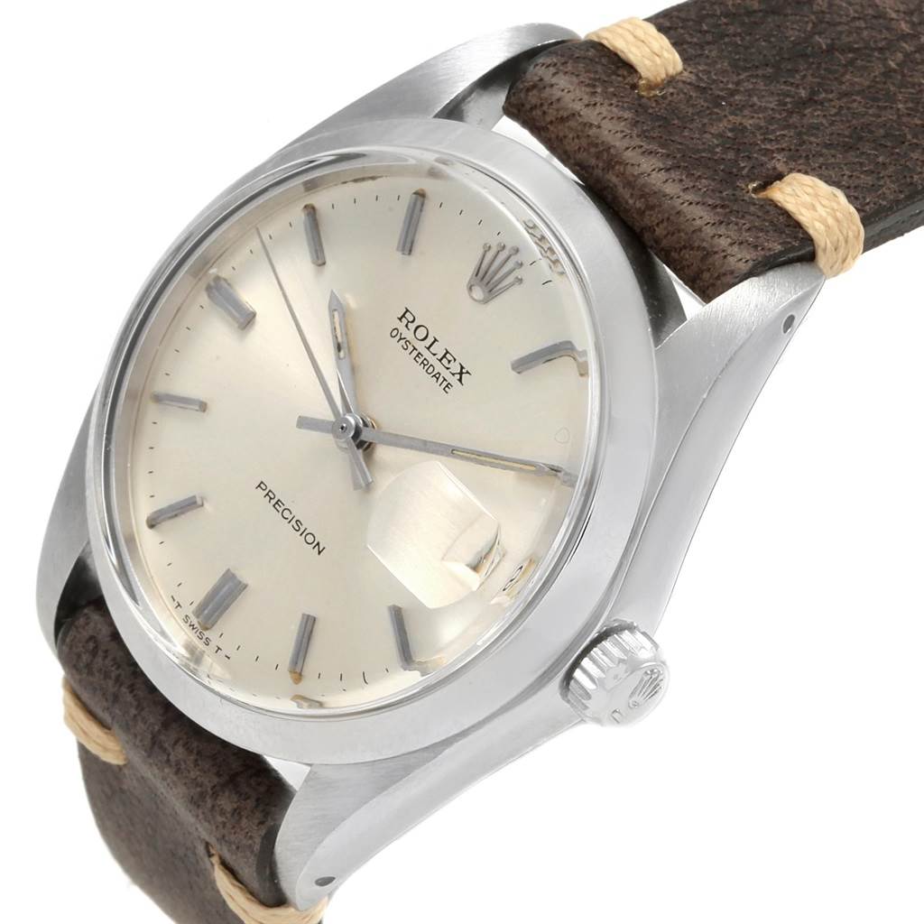This Rolex Vintage Collection 6694 Men
s Stainless Steel Silver Dial 6694 Men
s Stainless Steel Silver Dial watch is shown at an angle displaying the face, case, crown, and part of the leather strap.