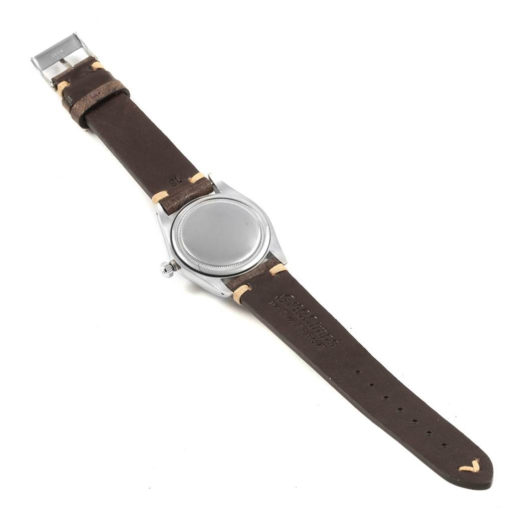 The image shows the back view of a Rolex Vintage Collection 6694 Men
s Stainless Steel Silver Dial 6694 Men
s Stainless Steel Silver Dial watch with a leather strap.