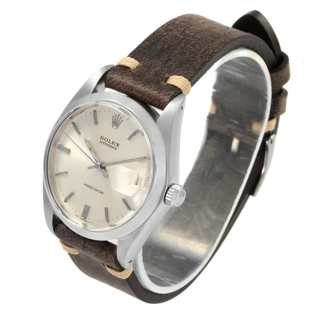 This image shows the Rolex Vintage Collection 6694 Men
s Stainless Steel Silver Dial 6694 Men
s Stainless Steel Silver Dial watch at an angle highlighting its dial, crown, and leather strap.