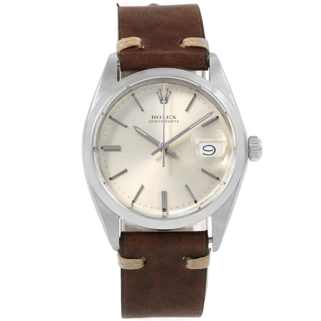 The image shows a Rolex Vintage Collection 6694 Men
s Stainless Steel Silver Dial 6694 Men
s Stainless Steel Silver Dial Oysterdate watch with a brown leather strap, silver dial, and date display at 3 o
clock.