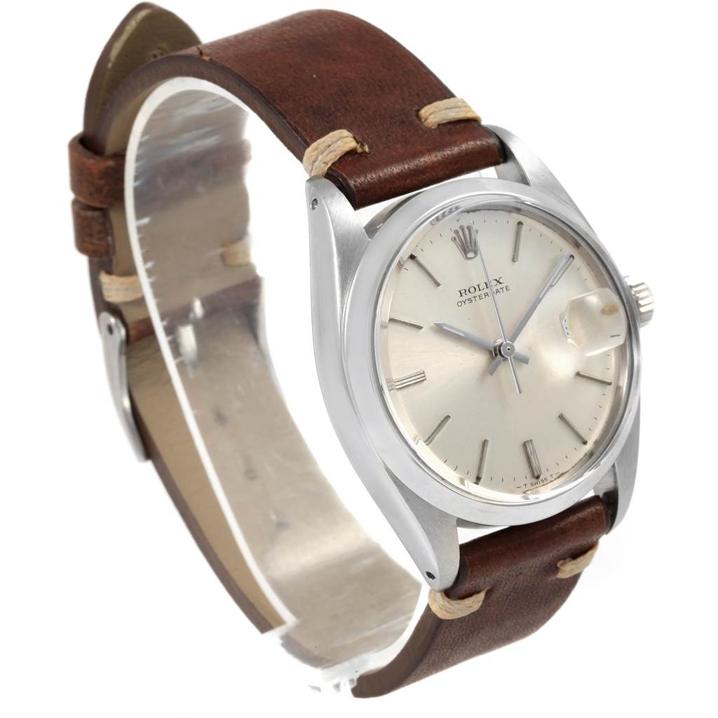 The photo shows a side angle of the Rolex Vintage Collection 6694 Men
s Stainless Steel Silver Dial 6694 Men
s Stainless Steel Silver Dial watch featuring its face, bezel, crown, and leather strap.