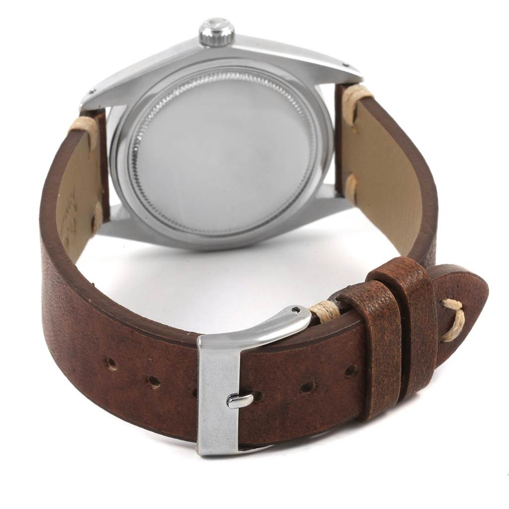 The image shows the back view of the Vintage Collection watch by Rolex, featuring the case back and leather strap with buckle.