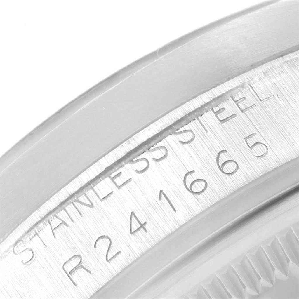 The close-up image shows the side engraving of a stainless steel Vintage Collection Rolex watch, displaying its serial number.