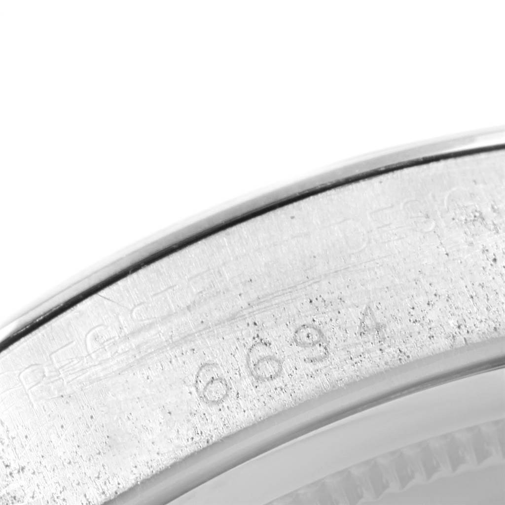 This close-up image shows part of the case back edge with engraved serial numbers of the Rolex Vintage Collection 6694 Men
s Stainless Steel Black Dial 6694 Men
s Stainless Steel Black Dial model.